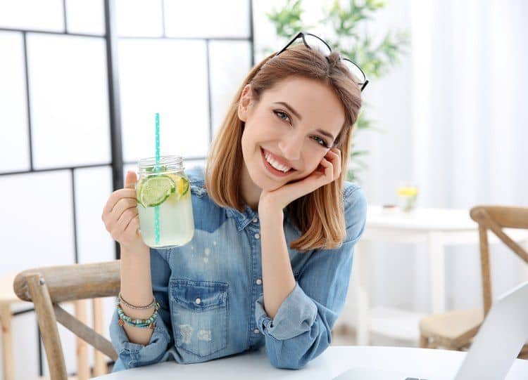 girl drinking fruit infused water