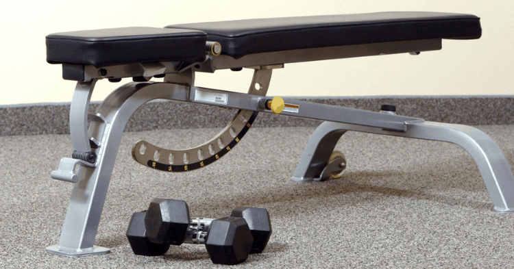 an adjustable weight bench at a home gym